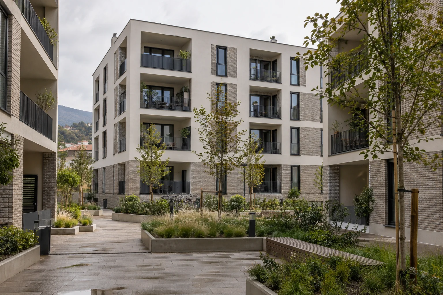 Contemporary residential buildings framing a landscaped shared courtyard
